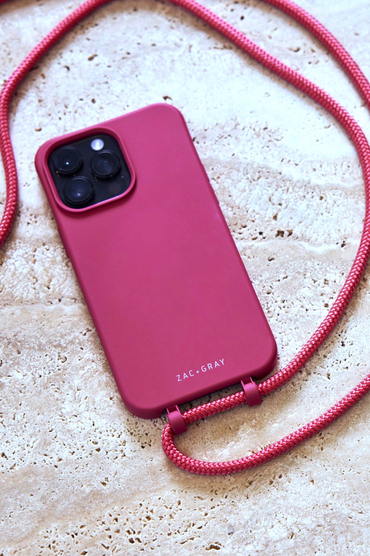 a pink case with a red cord attached to it