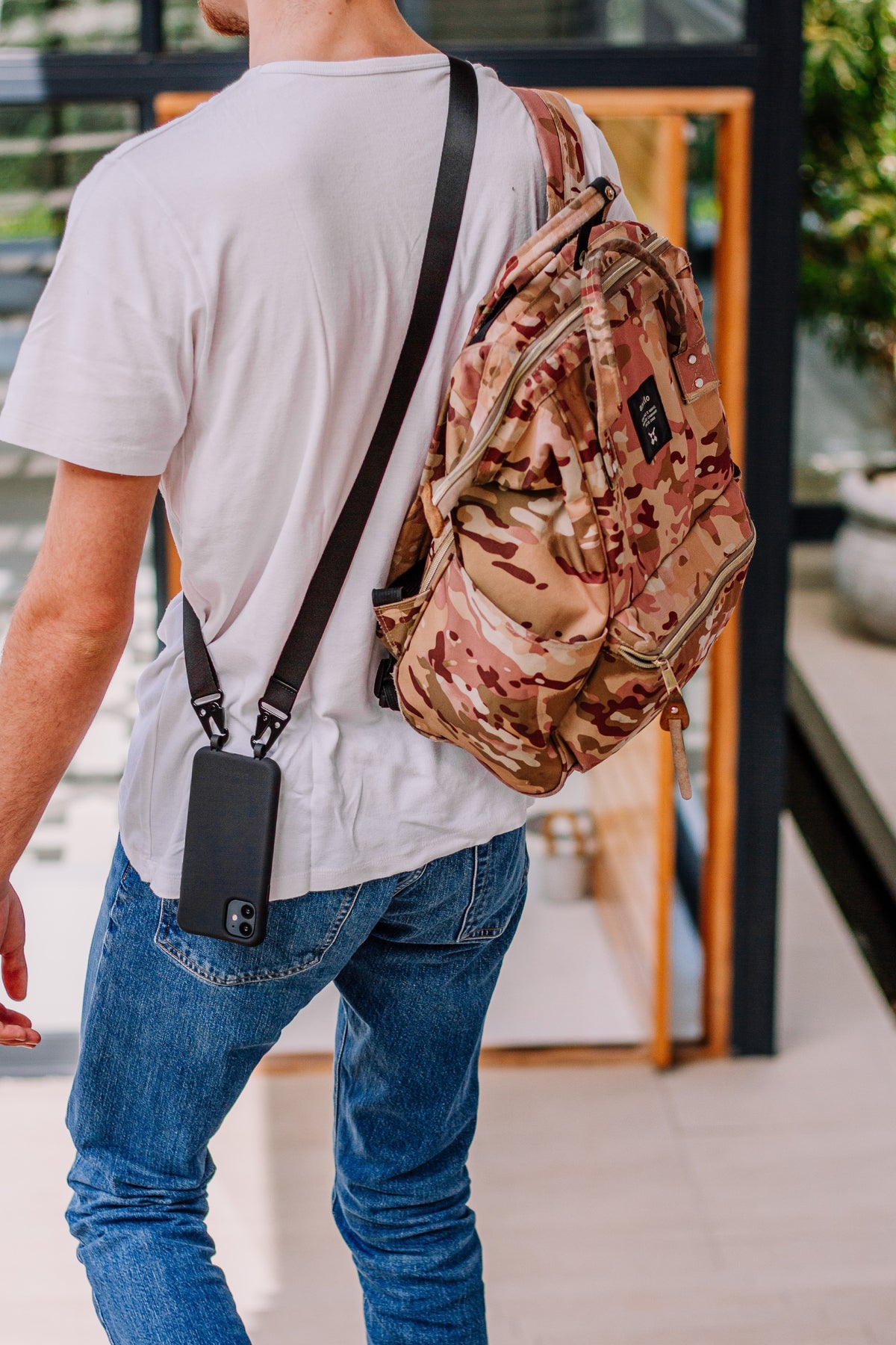 a man walking with a backpack on his back