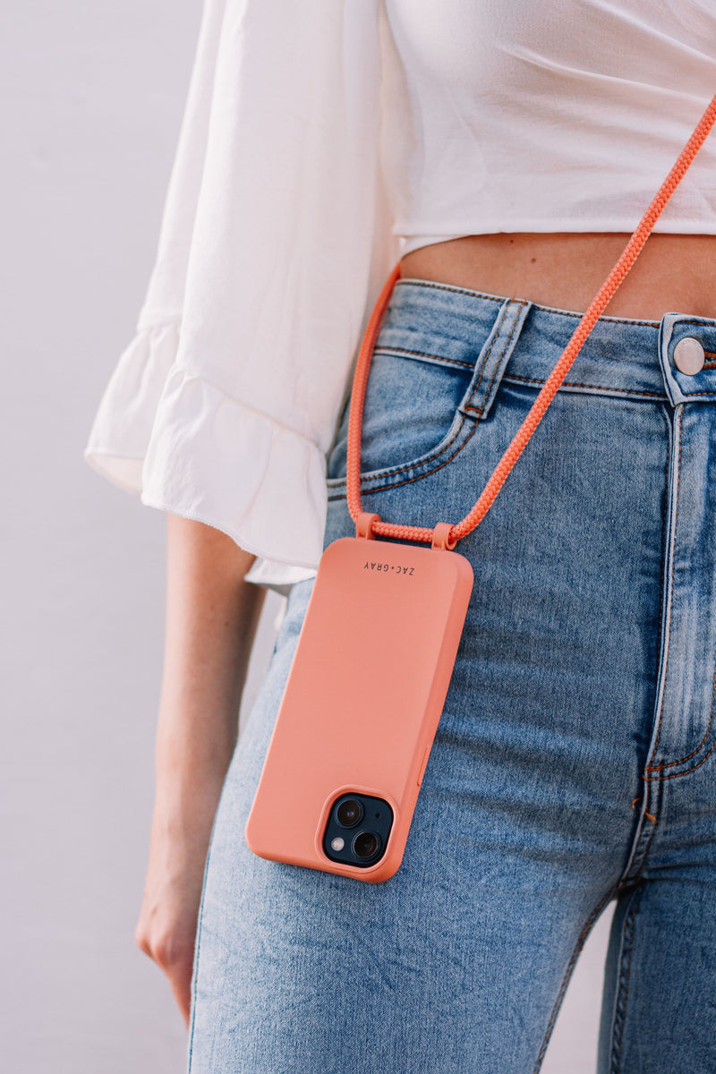 a woman holding a cell phone in her pocket