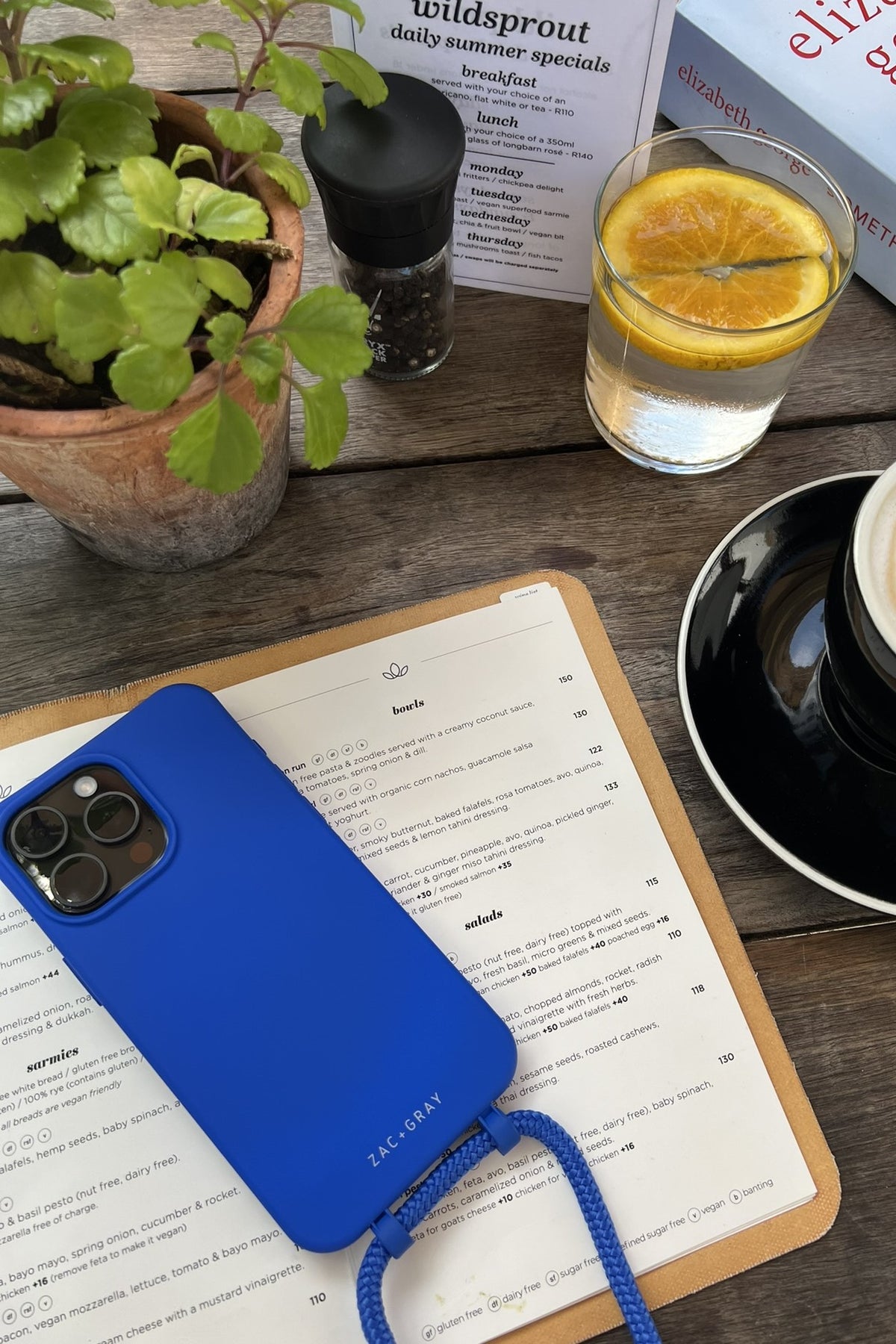 a blue phone case sitting on top of an open book