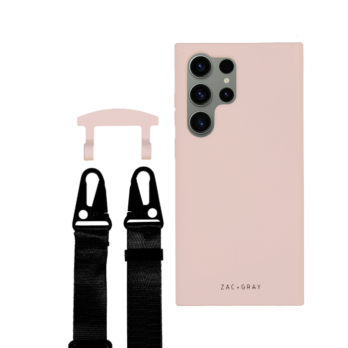 a pair of black suspenders are next to a pink phone case