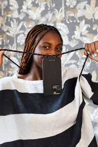 a woman holding up a cell phone in front of her face