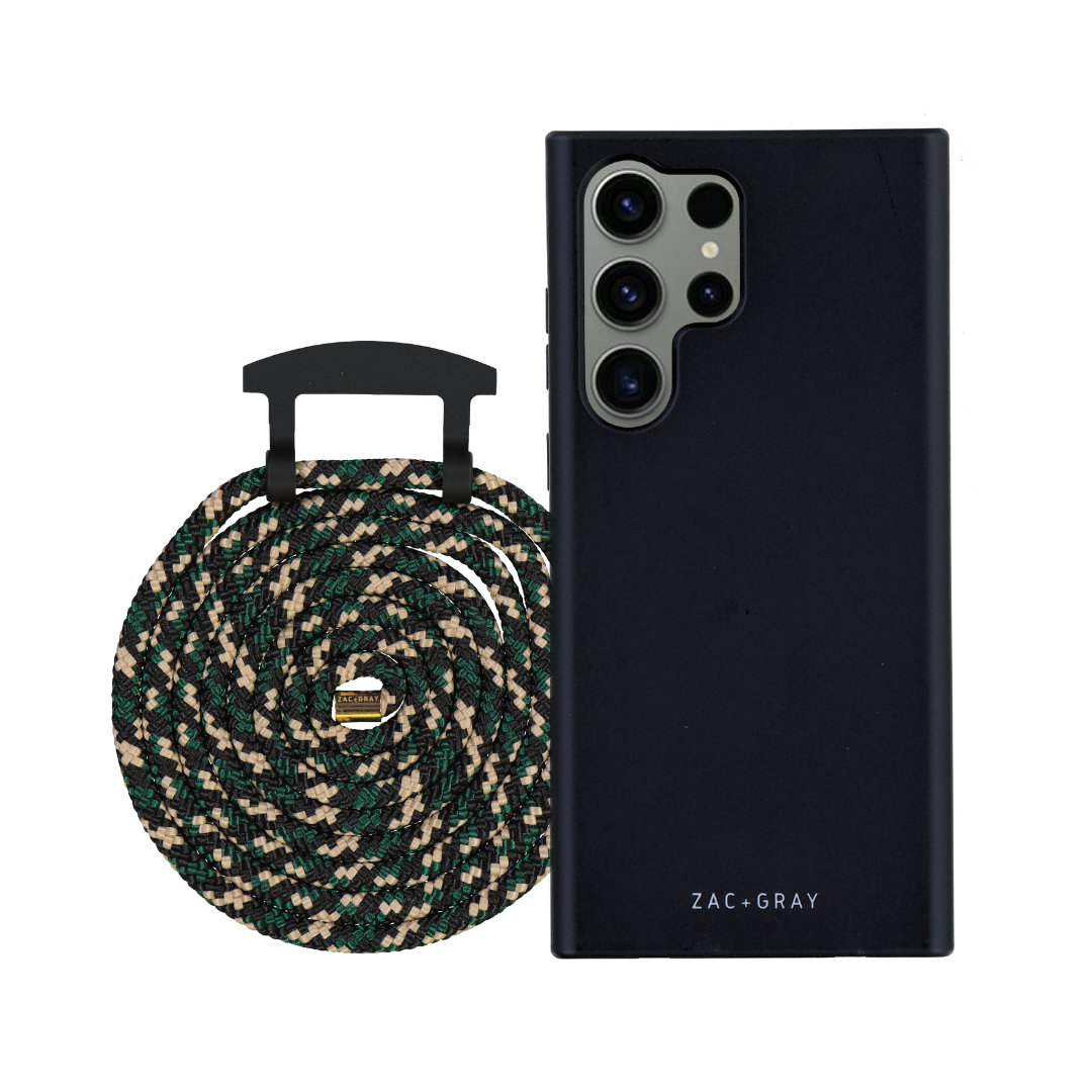 a black case with a green and white braided handle next to a black phone